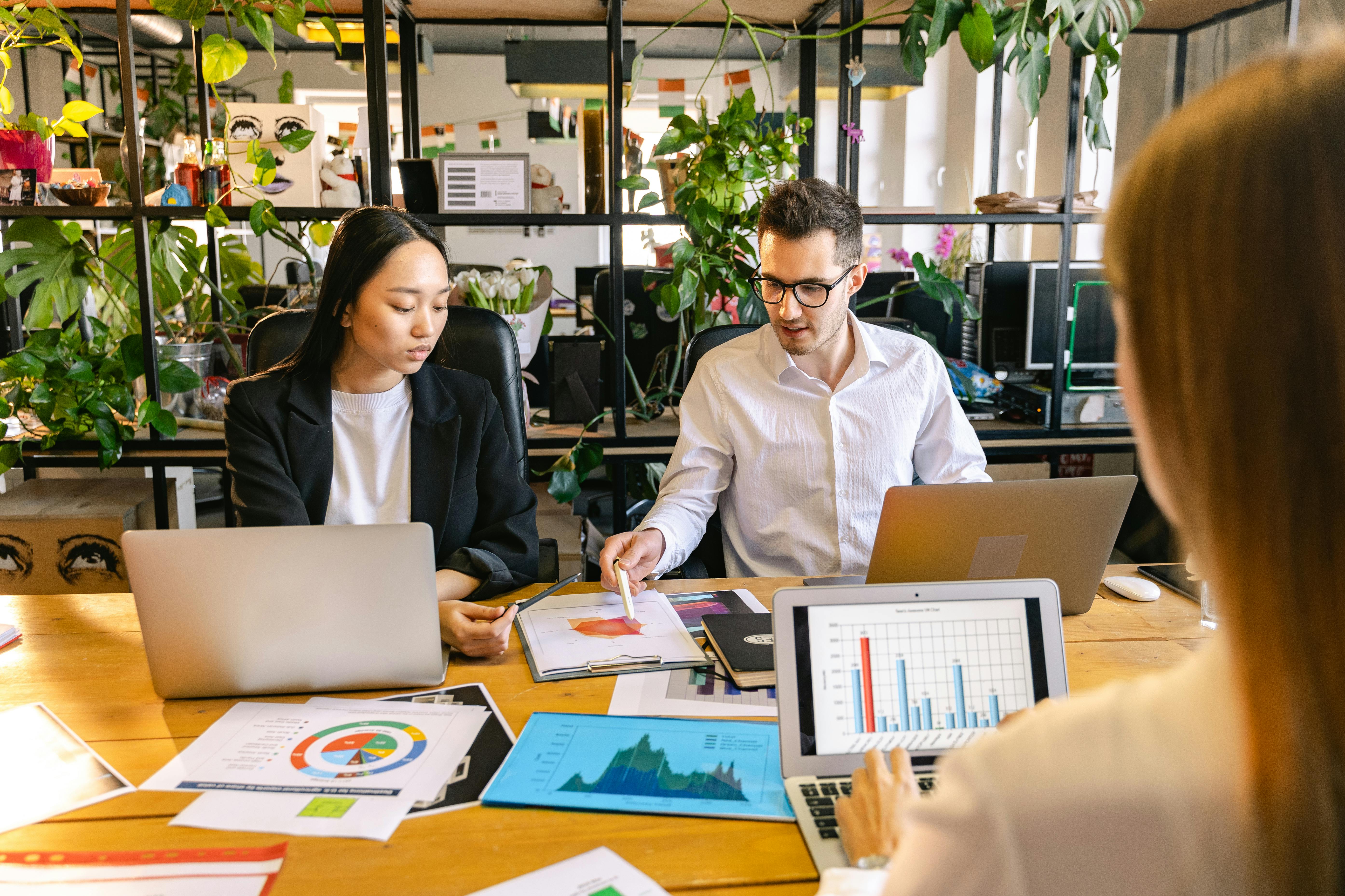 Professionals discussing website and project planning materials in a modern office